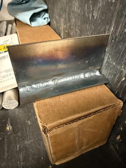 Two flat pieces of metal joined in a T shape, welded at the joint