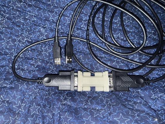 Two USB-RS232 adapters with a DE9 to DE9 null modem adapter connecting them together